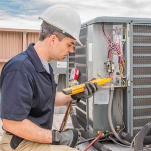 Technician working on a condensing unit